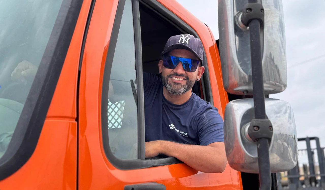 Nilo Group driver in an orange delivery truck