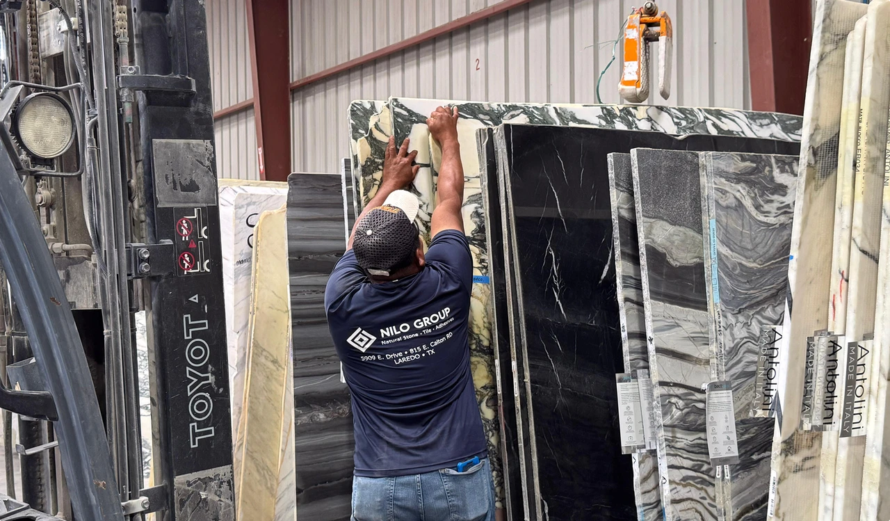 Nilo Group worker handling natural stone slabs