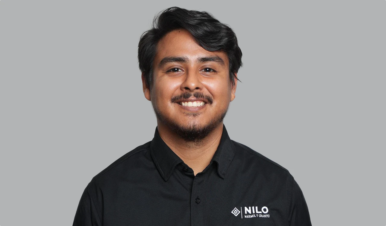 Smiling Nilo Group team member in a black uniform